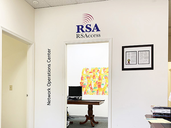 Another presentation of the logo and lettering as overlay graphic over real office photo.