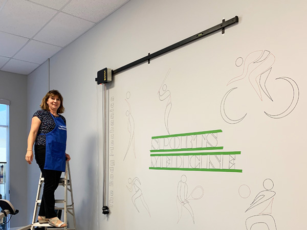 The upscaled office large mural lettering after the drawing robot. The traced images are ready for hand painting.
