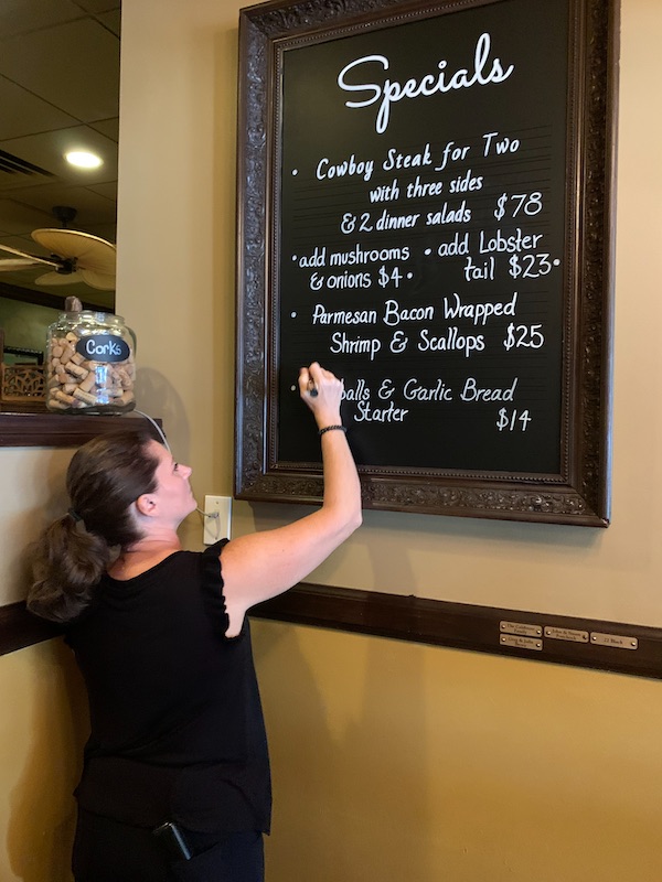 Botsy outlines chalkboard menu art for restaurants, cafes and bars. Using wet erase markers, the clients can edit the drawings easily.